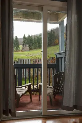 an open door to a porch with two chairs at Mountain Side Studio at The Blue Mountains in Blue Mountains