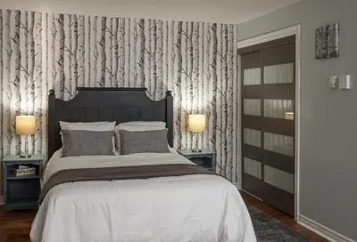 a bedroom with a large bed and two lamps at Mountain Side Studio at The Blue Mountains in Blue Mountains