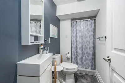 a bathroom with a white toilet and a shower at Modern Design Studio in Toronto