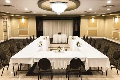 a large conference room with a long table and chairs at Rodeway Inn Festival in Stratford
