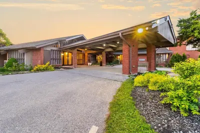an exterior view of a building with a driveway at Rodeway Inn Festival in Stratford