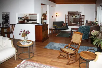 a living room with a couch and chairs at 2 Moon Cottage in Niagara on the Lake