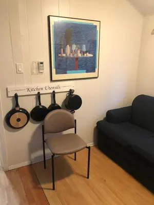 a living room with a chair and a couch at Wasaga Bridge Cottages in Wasaga Beach