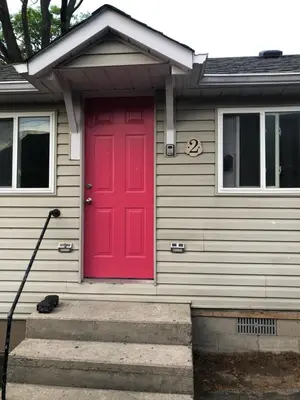 a red front door of a house with a red door at Wasaga Bridge Cottages in Wasaga Beach