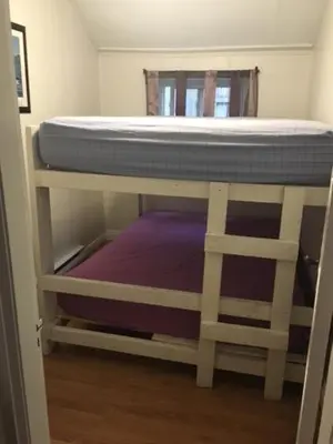 a bunk bed sitting on top of a room at Wasaga Bridge Cottages in Wasaga Beach