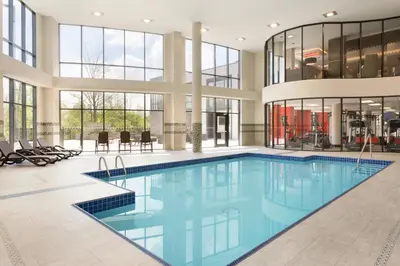 a large pool with blue water in a building at Courtyard by Marriott Toronto Mississauga/West in Mississauga