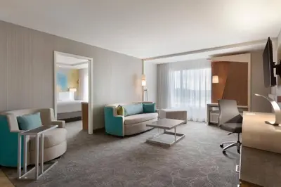 a hotel room with a couch and a bed at Courtyard by Marriott Toronto Mississauga/West in Mississauga