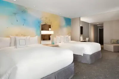 a hotel room with two beds and a couch at Courtyard by Marriott Toronto Mississauga/West in Mississauga