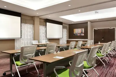 a conference room with wooden tables and chairs at Courtyard by Marriott Toronto Mississauga/West in Mississauga