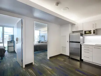 a kitchen with a stainless steel refrigerator in a room at Residence & Conference Centre - Toronto Downtown in Toronto