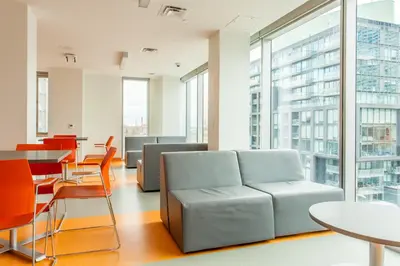 an office with a couch and a table and chairs at Residence & Conference Centre - Toronto Downtown in Toronto