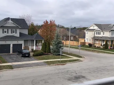 a house with a car parked in a driveway at Willow Pond Satellite B&B in Port Perry
