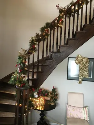 a stairway with christmas decorations and a christmas tree on it at Willow Pond Satellite B&B in Port Perry