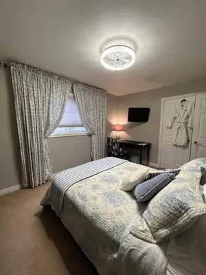 a bedroom with a bed and a window at Willow Pond Satellite B&B in Port Perry