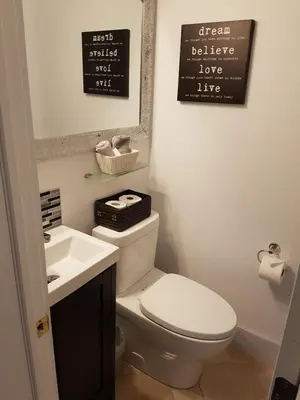 a bathroom with a white toilet and a sink at Newton Villa in Brampton