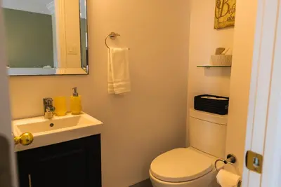 a bathroom with a white toilet and a sink at Newton Villa in Brampton