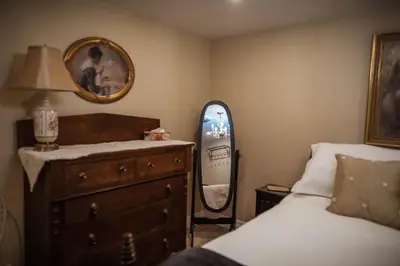 a bedroom with a bed and a dresser and a mirror at The Chepstow Inn in Chepstow
