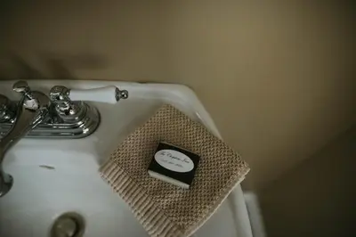 a bathroom sink with a soap box in a holder at The Chepstow Inn in Chepstow