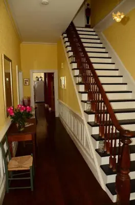 a hallway with a staircase in a house at The Chepstow Inn in Chepstow