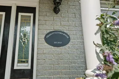 a sign on the front of a house at Charlottetown House in Niagara on the Lake