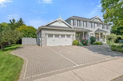 a house with a driveway and a garage at Charlottetown House in Niagara on the Lake
