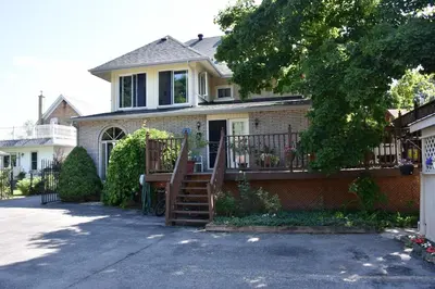 a house with a staircase leading to a porch at 10th Avenue Guest House & Suites in Hanover