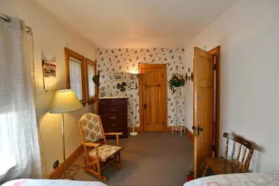 a bedroom with a bed and a desk and a chair at 10th Avenue Guest House & Suites in Hanover