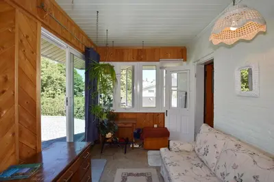a living room with a couch and some windows at 10th Avenue Guest House & Suites in Hanover