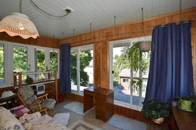 a living room with windows and a desk with a computer at 10th Avenue Guest House & Suites in Hanover