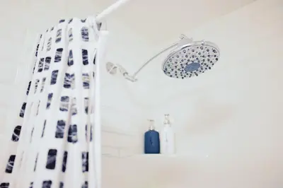 a shower with a shower head and a shower curtain at Edison's Inn in Stratford