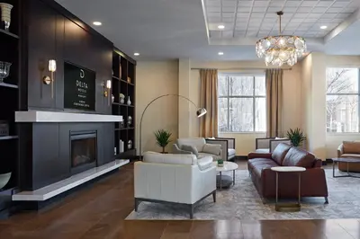a living room with a couch and a fireplace at Delta Hotels by Marriott Guelph Conference Centre in Guelph