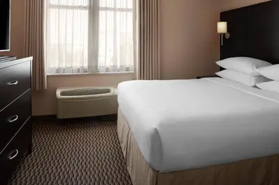 a hotel room with a large bed and a window at Delta Hotels by Marriott Guelph Conference Centre in Guelph