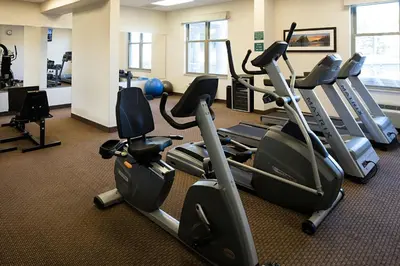 a gym with treadmills and elliptical machines at Delta Hotels by Marriott Guelph Conference Centre in Guelph