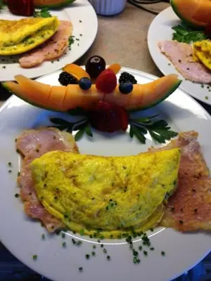 a plate of food with a face made out of food at Casa Blanca Boutique Bed & Breakfast in Niagara on the Lake