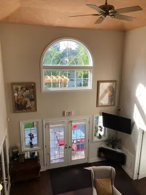 a living room with a ceiling fan and windows at Casa Blanca Boutique Bed & Breakfast in Niagara on the Lake