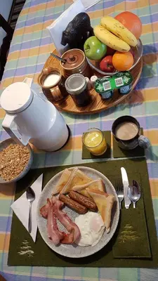 a table with two plates of breakfast foods on it at Bear & Butterfly Bed and Breakfast in Gravenhurst