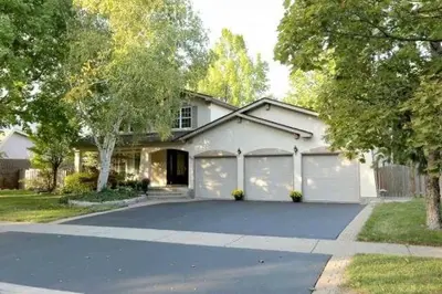 a white house with a garage and a driveway at Quiet and Comfortable Homestay in Oakville