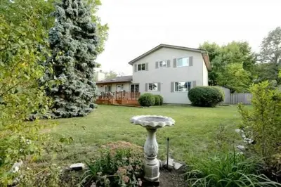a yard with a house and a birdbath in the yard at Quiet and Comfortable Homestay in Oakville