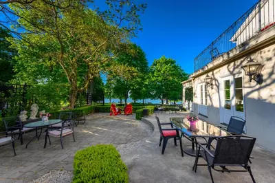 a patio with tables and chairs next to a building at The Old Bank House in Niagara on the Lake