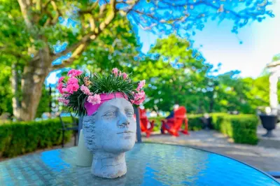 a statue of a head with a flower crown on it at The Old Bank House in Niagara on the Lake