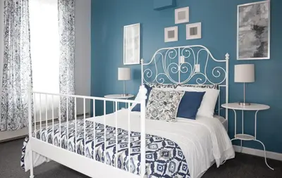 a bedroom with a white bed and blue walls at Dream Catcher Travel House in Toronto