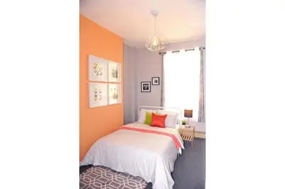 a bedroom with a bed and a window at Dream Catcher Travel House in Toronto