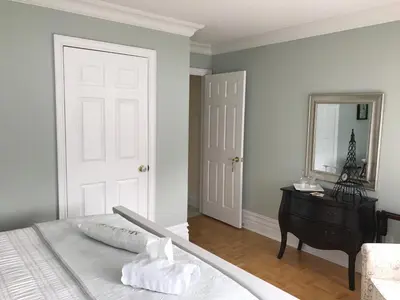 a bedroom with a bed and a dresser and a mirror at Molly's Retreat B and B in Orangeville