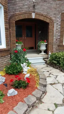 a front door of a house with red flowers at Molly's Retreat B and B in Orangeville