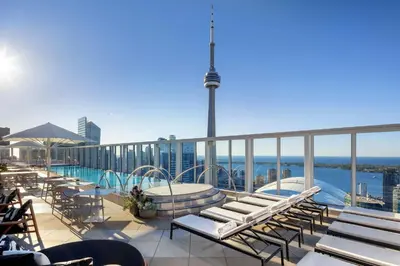 a balcony with chairs and a pool on a building at BISHA, a Luxury Collection Hotel, Toronto in Toronto