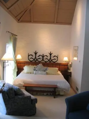 a bedroom with a large bed and a couch at Benmiller Inn & Spa in Goderich