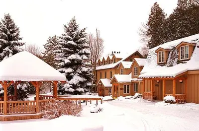 a snow covered yard with houses and a gazebo at Benmiller Inn & Spa in Goderich