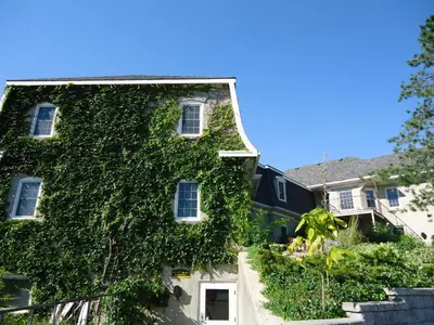 a building covered in ivy on a street at Benmiller Inn & Spa in Goderich