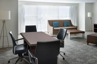 a conference room with a table and chairs and a couch at Toronto Marriott City Centre Hotel in Toronto