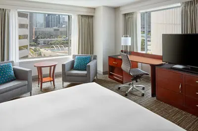a hotel room with a desk and a computer and chairs at Marriott Downtown at CF Toronto Eaton Centre in Toronto